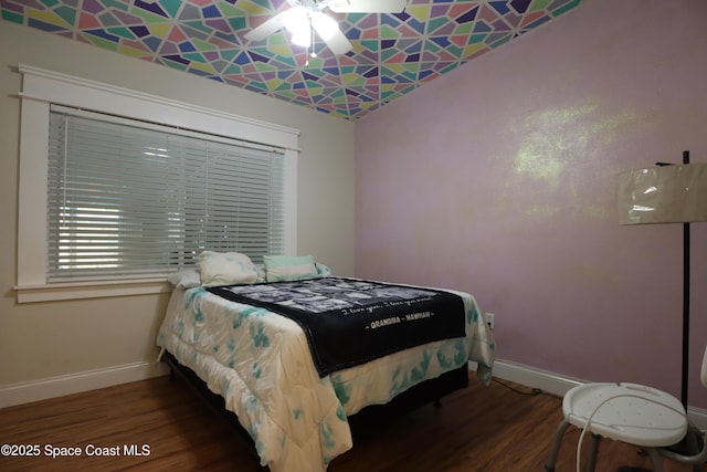 bedroom with wood finished floors and baseboards