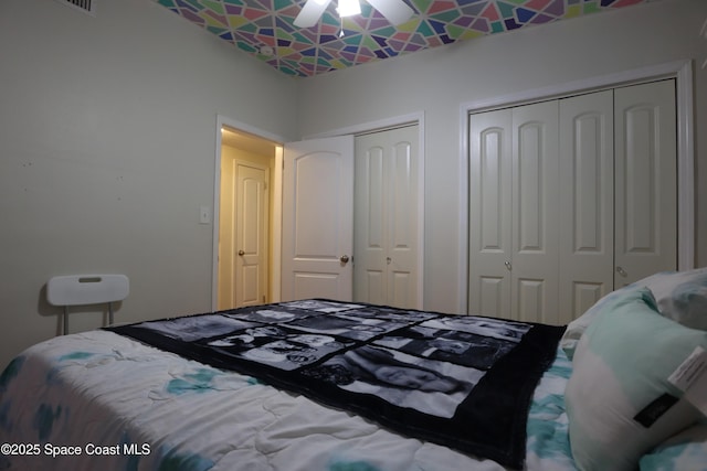 bedroom featuring two closets and ceiling fan