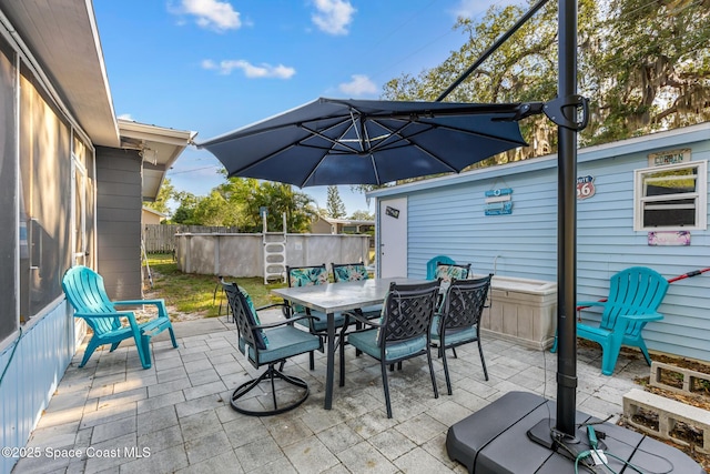 view of patio featuring fence and outdoor dining space