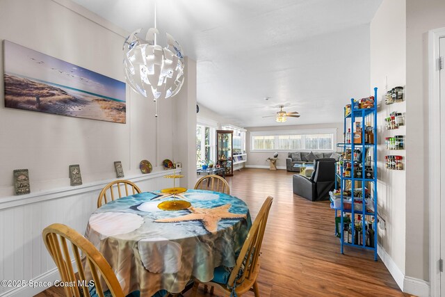 dining room with baseboards, wood finished floors, and ceiling fan