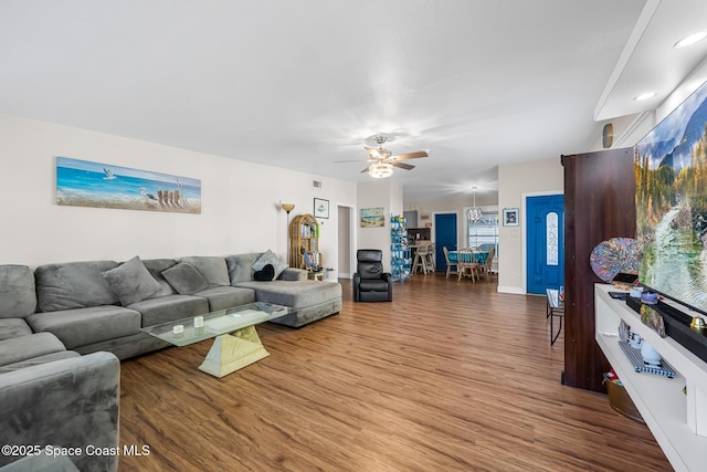 living room with wood finished floors, ceiling fan, baseboards, visible vents, and recessed lighting