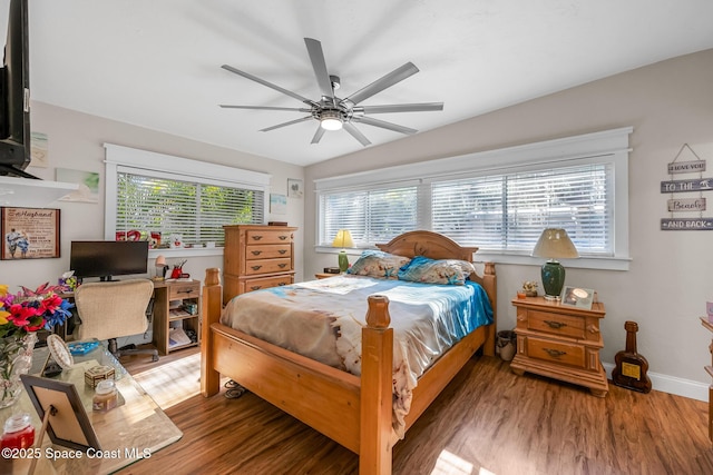 bedroom with wood finished floors, baseboards, and ceiling fan