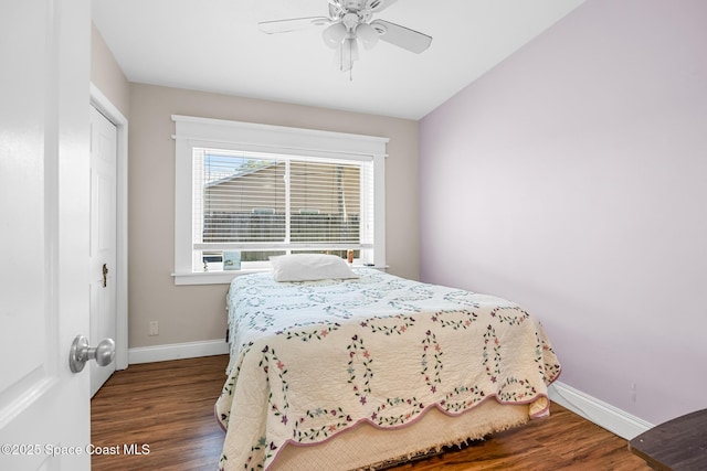 bedroom with ceiling fan, baseboards, and wood finished floors