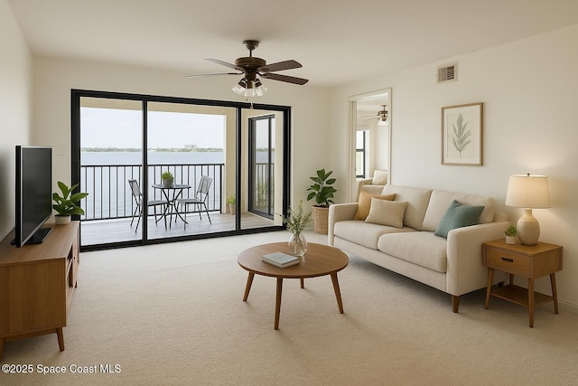 3601 S Banana River Blvd Unit A202, Cocoa Beach, FL 32931 - living area with carpet floors, a ceiling fan, and a water view