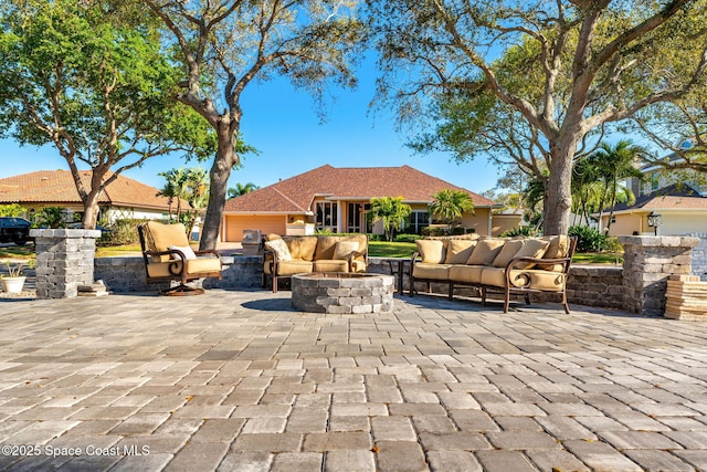 view of patio / terrace featuring an outdoor living space with a fire pit