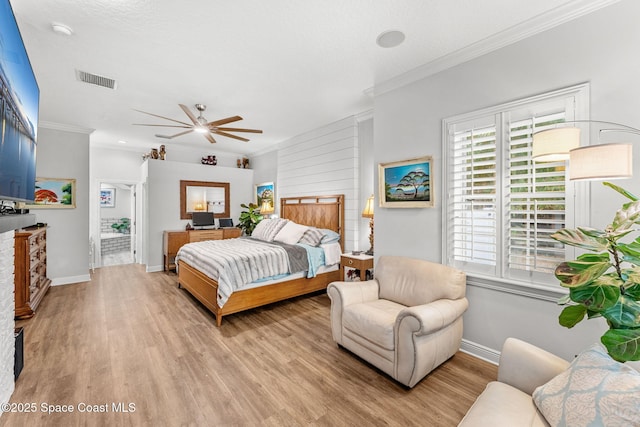 bedroom with a fireplace, light wood-type flooring, and ornamental molding