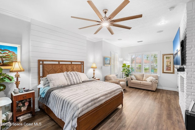 bedroom with visible vents, ornamental molding, a fireplace, and wood finished floors