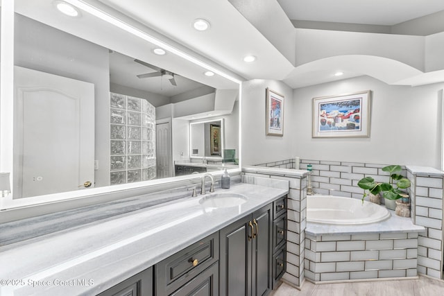 bathroom featuring a bath, recessed lighting, vanity, and a ceiling fan