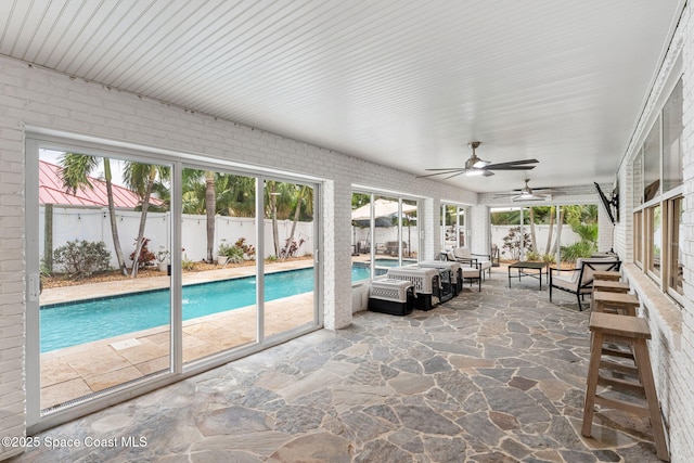 exterior space with a patio area, a fenced in pool, a ceiling fan, and a fenced backyard