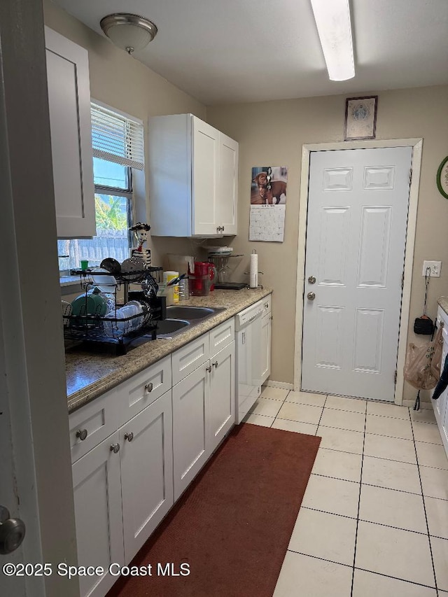 kitchen featuring dishwasher, light countertops, and white cabinetry