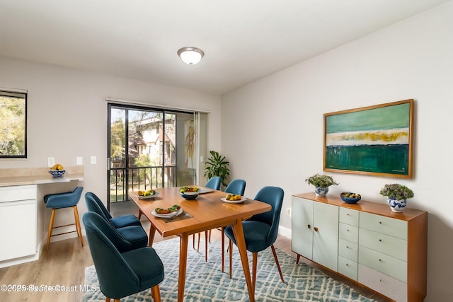 office space with light wood-type flooring and baseboards