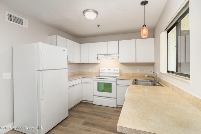 kitchen with light wood finished floors, visible vents, under cabinet range hood, white appliances, and a sink