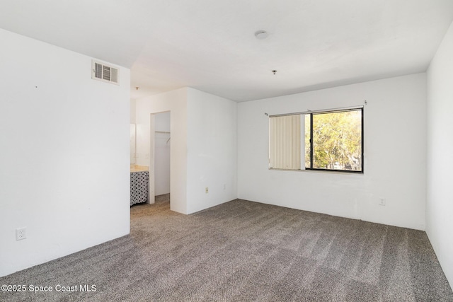 carpeted empty room with visible vents