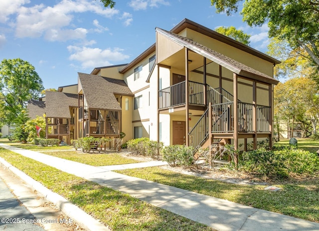 7814 Shadowood Dr Unit 512, Melbourne, FL 32904 - view of building exterior with stairway and a residential view