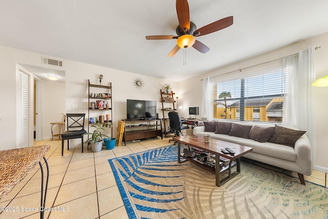 living room featuring light tile patterned floors, visible vents, and ceiling fan