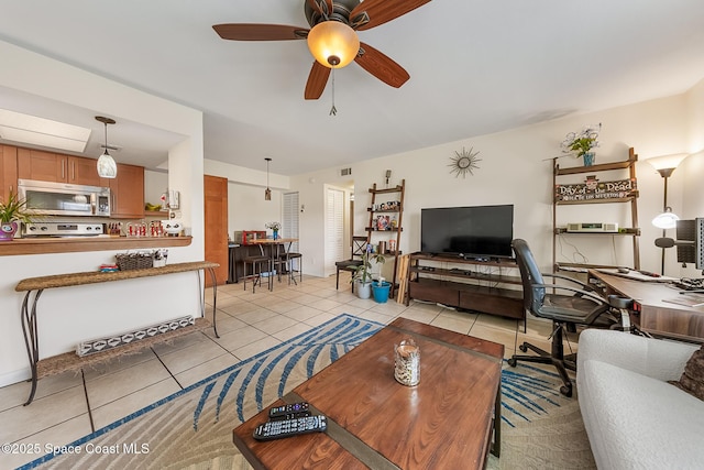 living room with ceiling fan, visible vents, and light tile patterned flooring