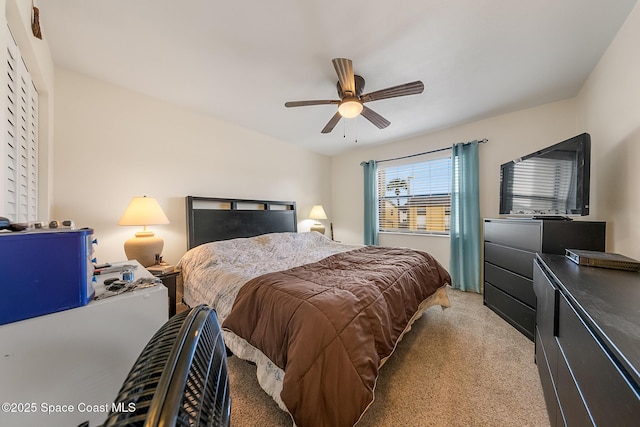 bedroom with light colored carpet and a ceiling fan