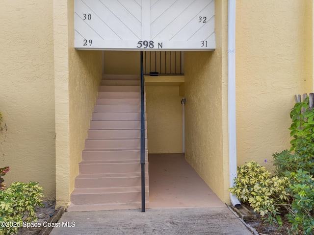 property entrance with stucco siding