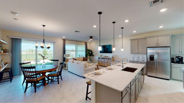 kitchen with visible vents, marble finish floor, stainless steel refrigerator with ice dispenser, and a sink