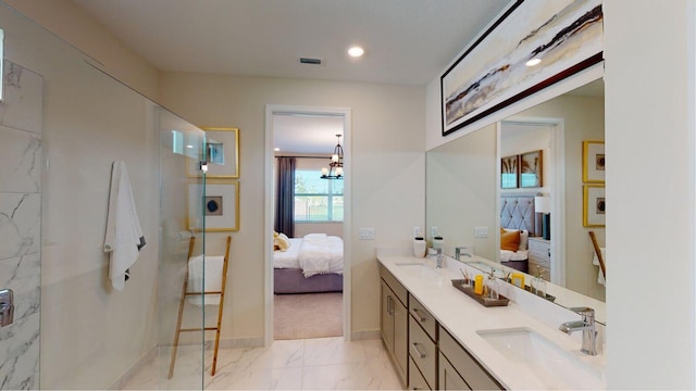 bathroom with a marble finish shower, connected bathroom, marble finish floor, and a sink