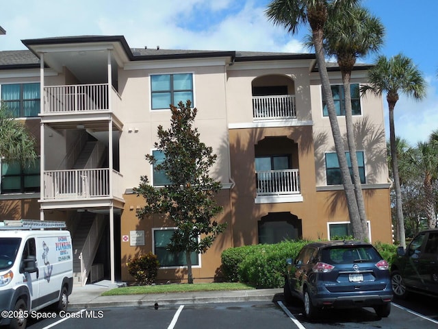 view of building exterior with uncovered parking