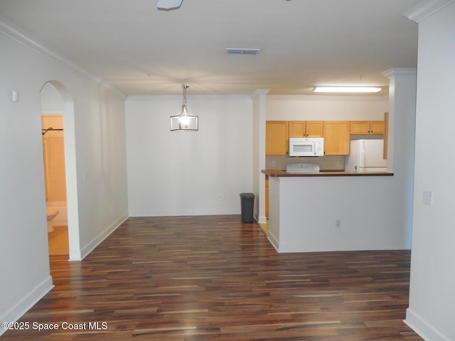 kitchen featuring dark countertops, visible vents, crown molding, white appliances, and dark wood-style flooring