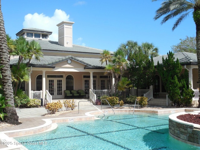 pool with a patio and french doors