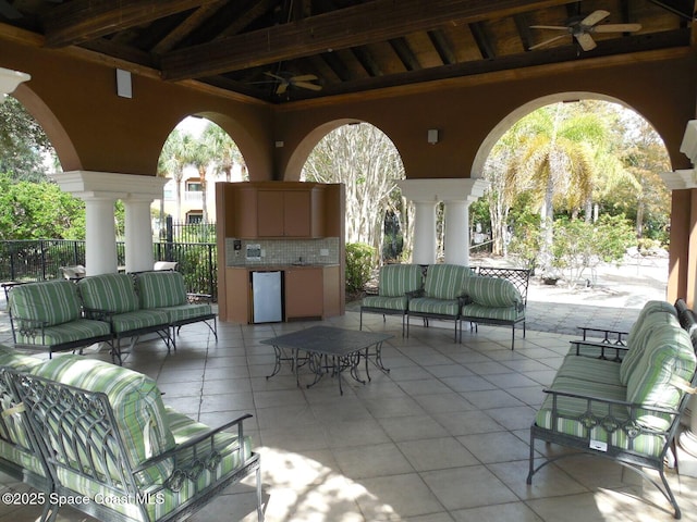 view of patio / terrace with an outdoor hangout area, a ceiling fan, and fence