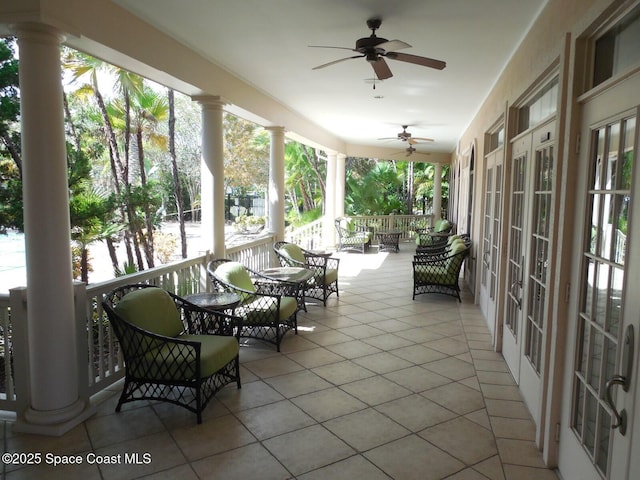 sunroom / solarium featuring ornate columns and ceiling fan