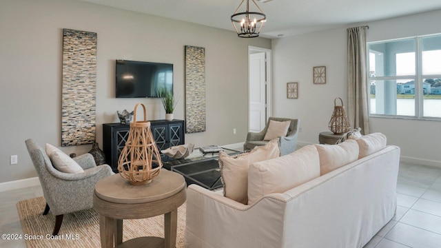 living room with light tile patterned flooring, baseboards, and a chandelier