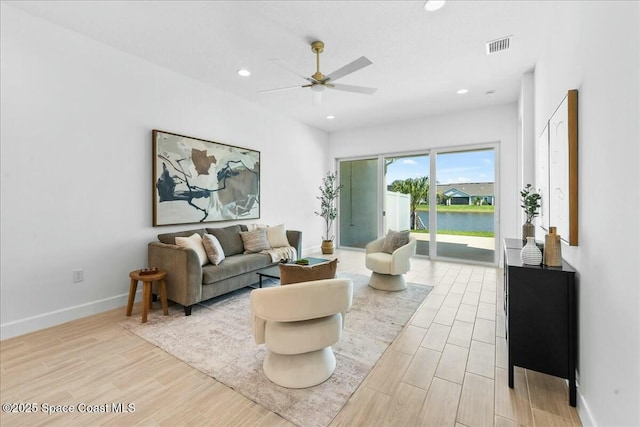 living room with recessed lighting, ceiling fan, baseboards, and light wood-type flooring