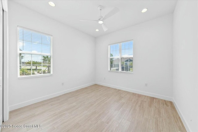 empty room featuring baseboards, a ceiling fan, light wood-style floors, and recessed lighting