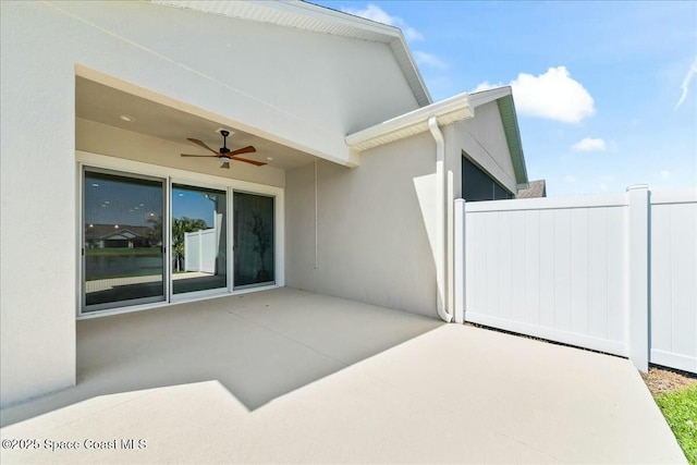 view of patio / terrace with fence and a ceiling fan