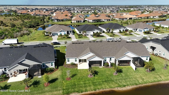 birds eye view of property with a residential view and a water view