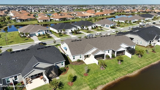 birds eye view of property with a residential view and a water view