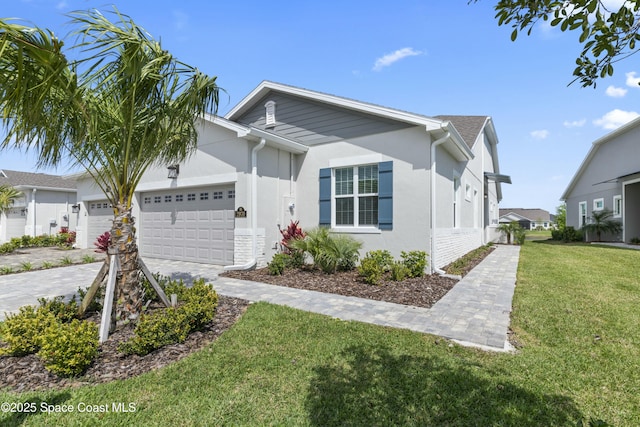 single story home with a garage, driveway, a front lawn, and stucco siding