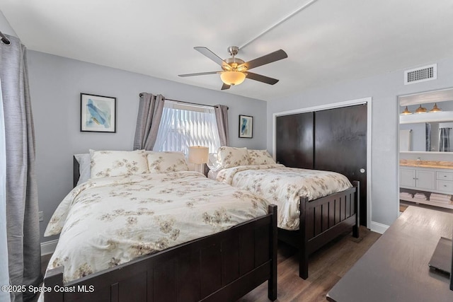 bedroom featuring visible vents, dark wood finished floors, a closet, connected bathroom, and ceiling fan