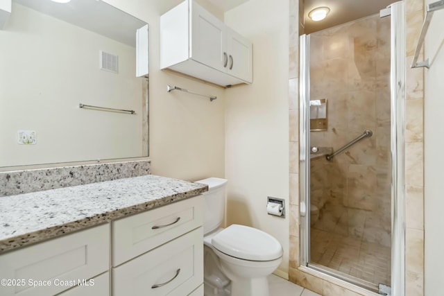 full bath featuring vanity, toilet, visible vents, and a stall shower