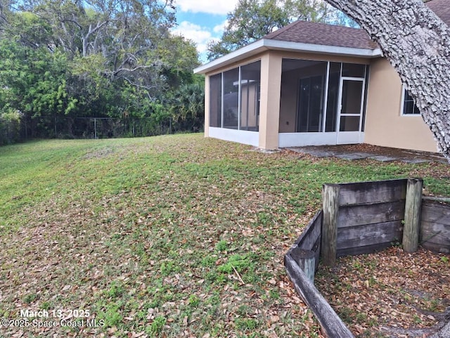 view of yard featuring fence and a sunroom