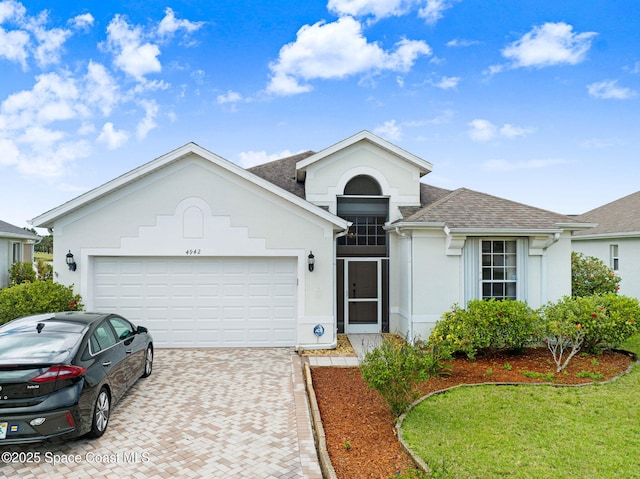 4942 Worthington Cir, Rockledge, FL 32955 - single story home featuring roof with shingles, stucco siding, decorative driveway, and an attached garage