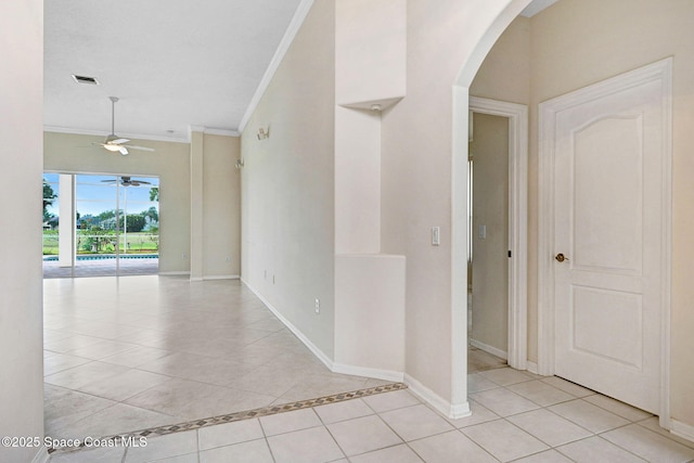 4942 Worthington Cir, Rockledge, FL 32955 - unfurnished room featuring crown molding, light tile patterned floors, arched walkways, and ceiling fan