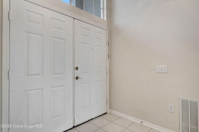 4942 Worthington Cir, Rockledge, FL 32955 - entryway with baseboards and light tile patterned flooring
