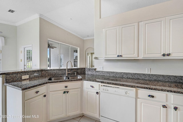 4942 Worthington Cir, Rockledge, FL 32955 - kitchen featuring white dishwasher, a peninsula, dark stone countertops, white cabinets, and ornamental molding