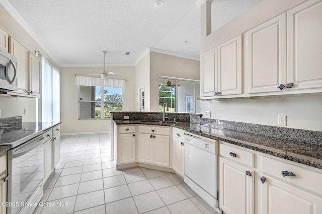 4942 Worthington Cir, Rockledge, FL 32955 - kitchen with white dishwasher, range with electric cooktop, a ceiling fan, crown molding, and a peninsula