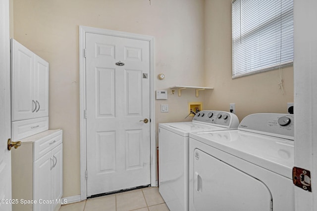 4942 Worthington Cir, Rockledge, FL 32955 - laundry area featuring washing machine and clothes dryer, cabinet space, and light tile patterned floors