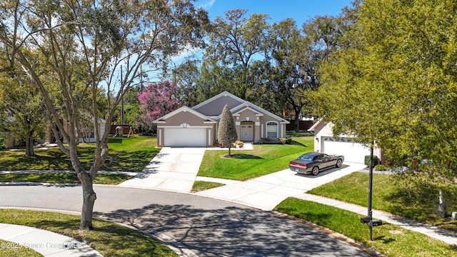 view of front of home with a front yard, concrete driveway, a garage, and stucco siding