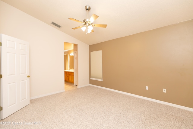 unfurnished bedroom with visible vents, baseboards, light colored carpet, and vaulted ceiling