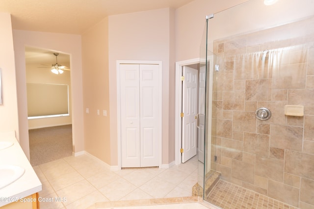 full bath with tile patterned flooring, a shower stall, a closet, and double vanity