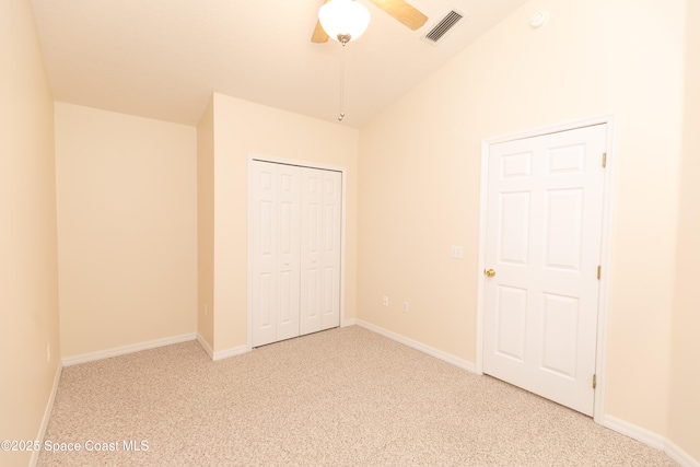 unfurnished bedroom with baseboards, visible vents, ceiling fan, a closet, and carpet flooring