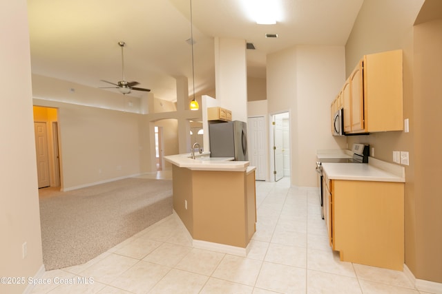 kitchen with high vaulted ceiling, arched walkways, ceiling fan, appliances with stainless steel finishes, and light colored carpet